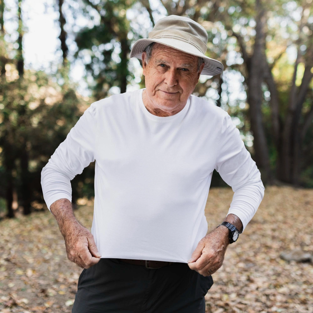 Senior Patios Dallas client standing outdoors near landscaped area